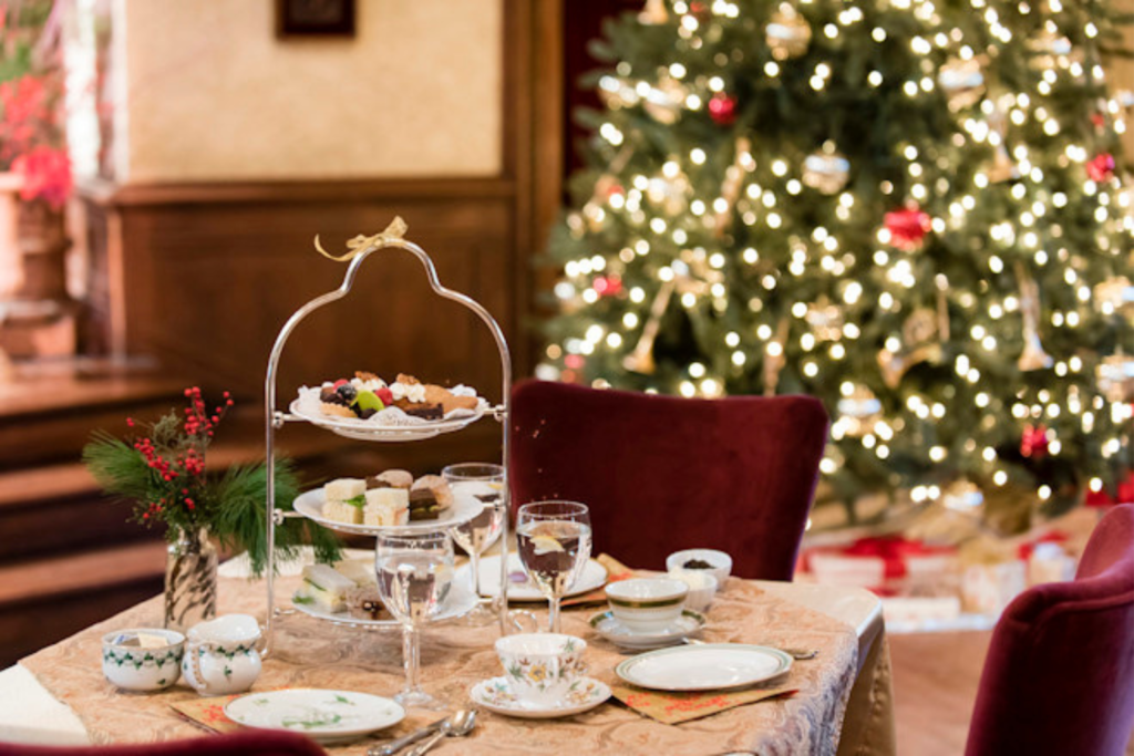 A festive photograph of the Holiday Tea set with a Christmas tree in the background. Come enjoy!
